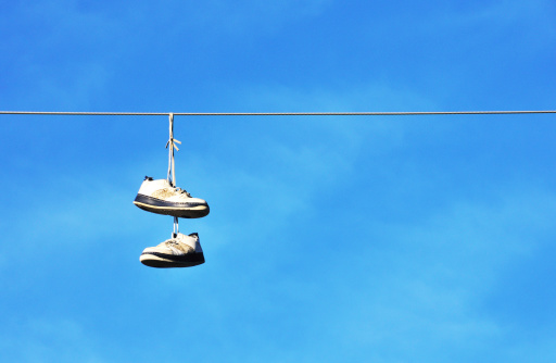 Tennis shoes hanging from power line.