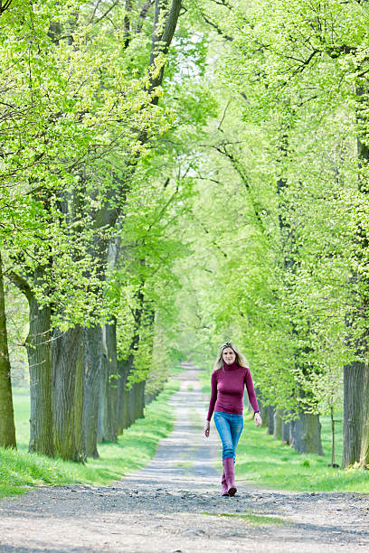istock woman in spring alley 162138422