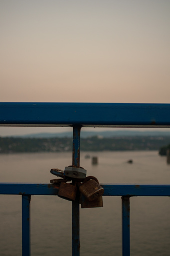 Padlocks on a bridge over Danube River. Symbol and concept of love.
