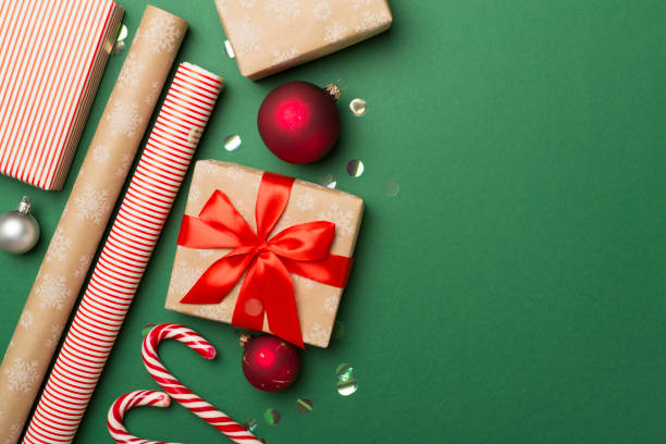 istock Gift boxes, paper's rools and decorations on color background, top view 1621395724