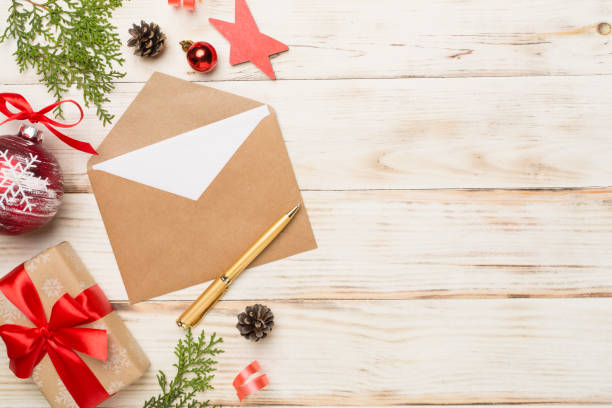istock Craft envelope with christmas decoration on wooden background, top view 1621395838