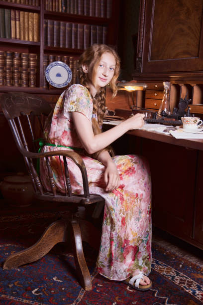 istock Young lady at her writing desk in the old study. 1621409127