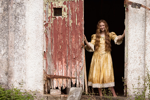 Gypsy girl outside her decayed house. Posed by a model.