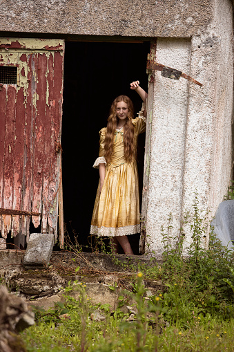 Gypsy girl looking out of her decayed house. Posed by a model.