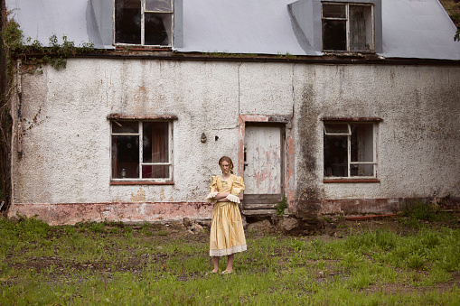 Gypsy girl outside her decayed house. Posed by a model.