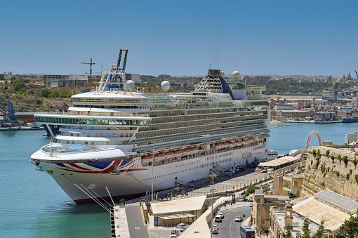 Sydney, NSW, Australia , December 20 2017. An elevated view from the Sydney Harbour Bridge of the Nassau Voyager of the Seas cruise ship at Circular Quay, Sydney, NSW, Australia. The cityscape of Sydney in the background. Voyager Off The Seas is a luxury cruise ship, operated by Royal Caribbean International.