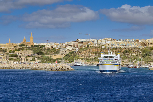 Gozo, Malta - 5 August 2023: Ferry leaving Mgarr harbour taking vehicles and passengers to the main island of Malta.The ferry is operated by Gozo Channel Line.
