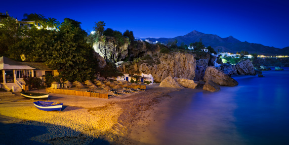 Night view of Nerja Beach in Andalucia southern of Spain. Sierra Nevada in the background
