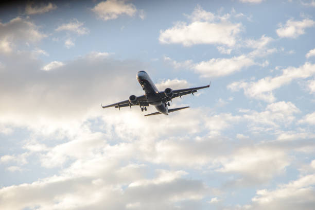 istock plane flying in the sky with clouds in Rio de Janeiro. 1621419774