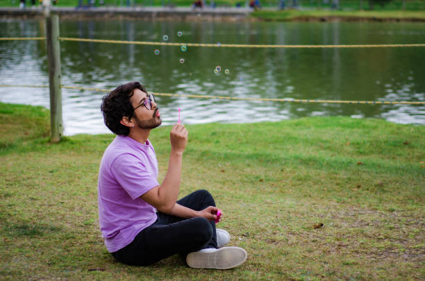 istock gay man playing with soap bubbles 1621430320