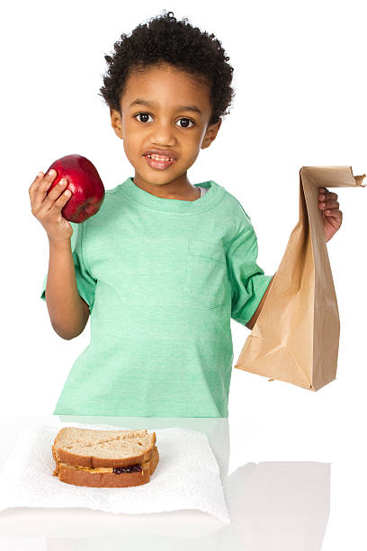 young boy with el almuerzo - packed lunch paper bag apple lunch fotografías e imágenes de stock