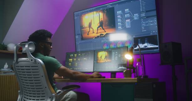 istock African American video editor makes color grading on PC 1621436804