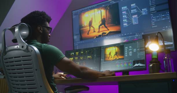 istock African American video editor makes color grading on PC 1621438955