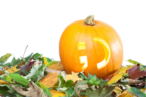 Studio shot of a single, isolated pumpkin with wink smiley on white background.