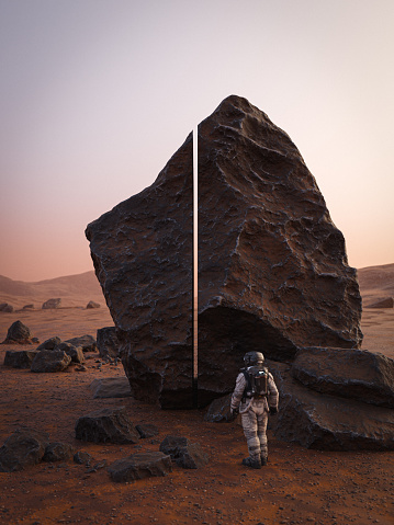 An astronaut examining an alien rock