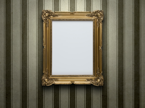 Blank gold picture frame at grunge striped wall with copy space
