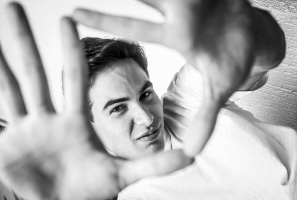 istock Portrait of a young man seen through his hands 1621451230