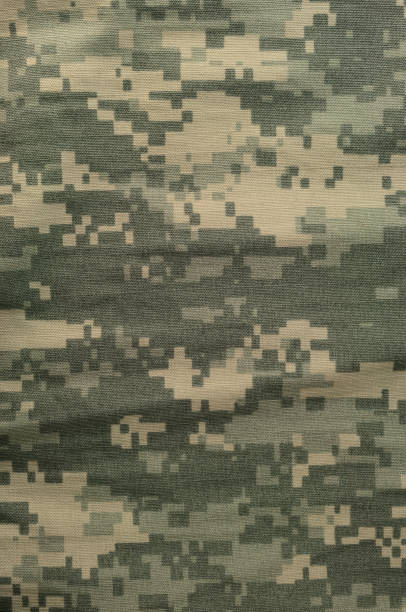istock Universal camouflage pattern, army combat uniform digital camo, USA military ACU macro closeup, detailed large rip-stop fabric texture background, crumpled, wrinkled, foliage green, yellow desert sand tan, urban gray grey NYCO, nylon, cotton, vertical 1621451758