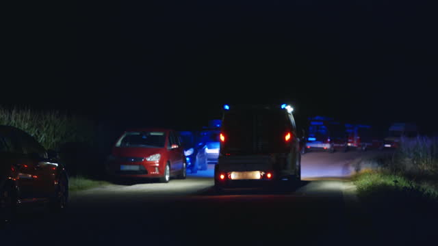 SLO MO Car Following Firetruck Flashing Blue Lights Moving on Road at Night