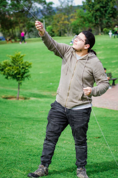 istock young man flying a kite in the park 1621468725