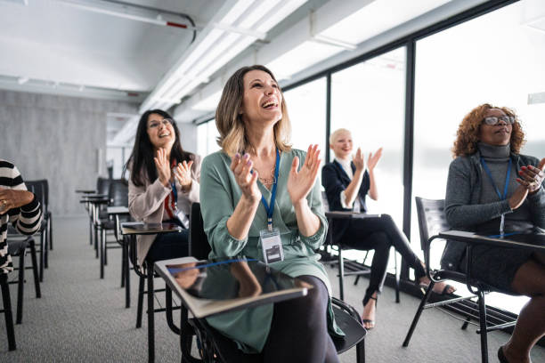 istock Businesswomen clapping during meeting at office 1621469774