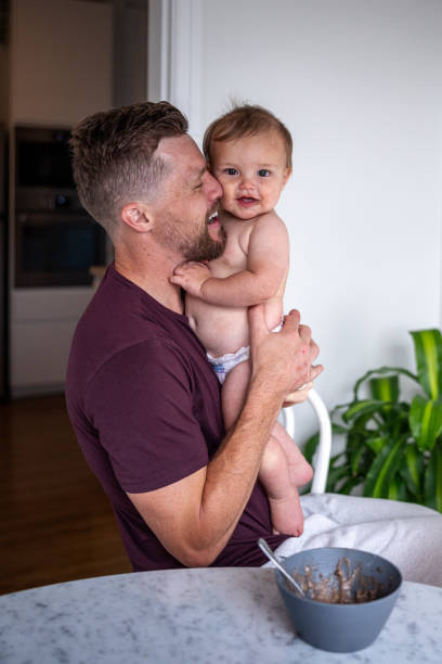 istock Father holds son at the dining table, smiling 1621469832