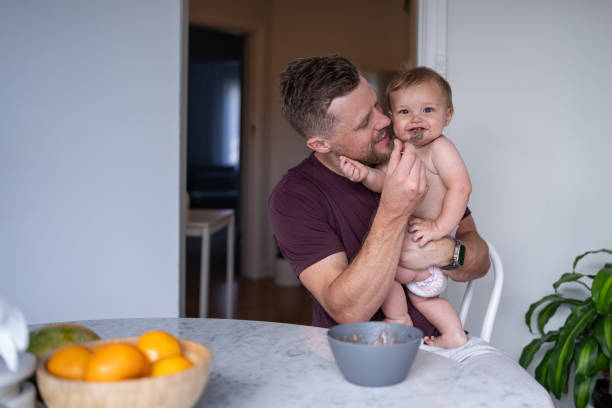 istock Father holds son at the dining table, smiling 1621469840