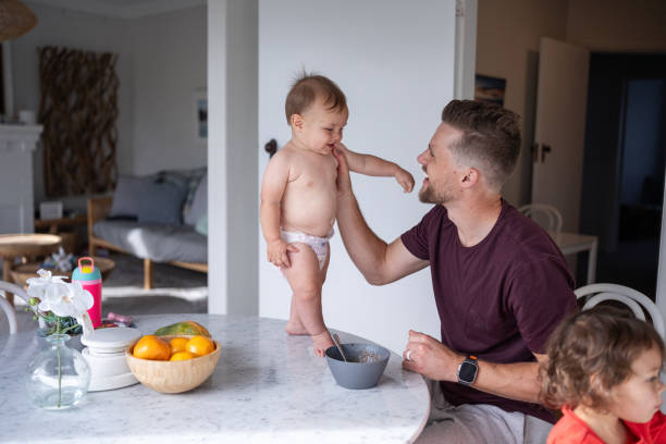 istock Father and son play at dining room table together 1621469842