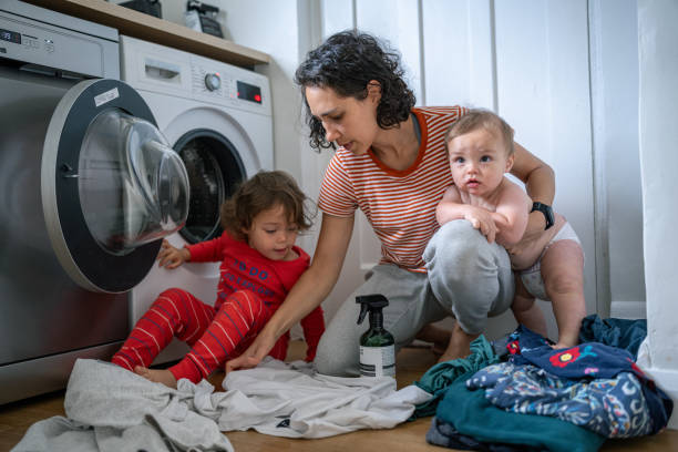 istock Mother and her son and daughter do laundry together 1621469849