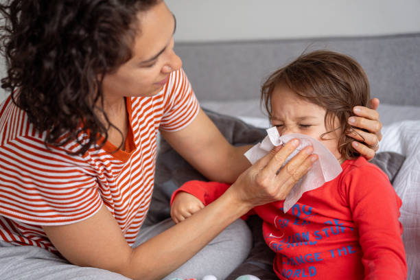 istock Toddler sick with a cold at home with her mom 1621469852