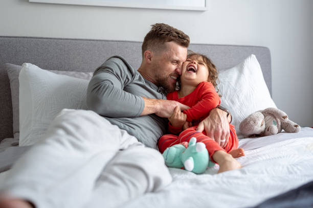 istock Loving father tickles giggling young daughter 1621469857