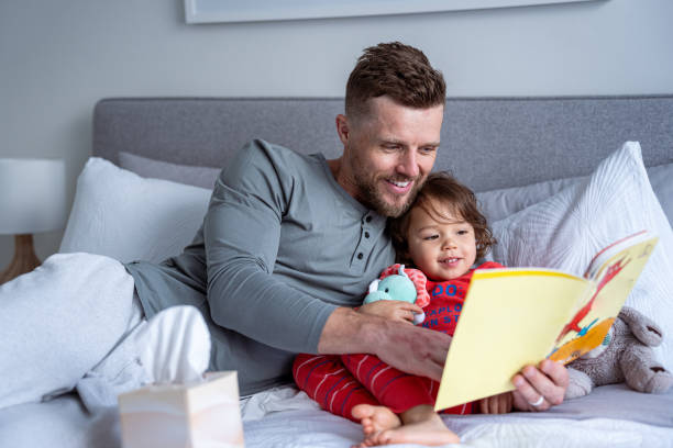 istock Toddler sick with a cold at home with her dad 1621469860