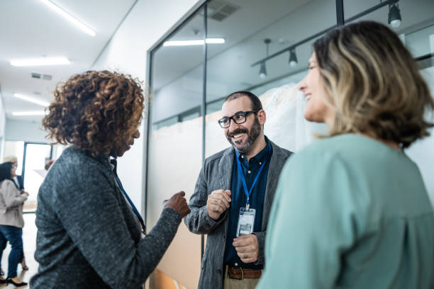 istock Coworkers talking at corridor during a business seminar 1621470928
