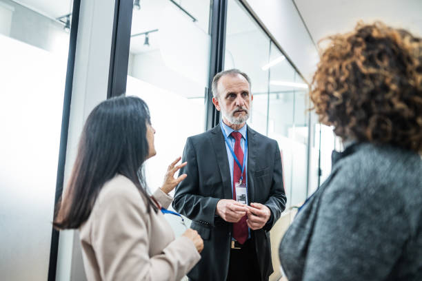 istock Coworkers talking at corridor during a business seminar 1621470943