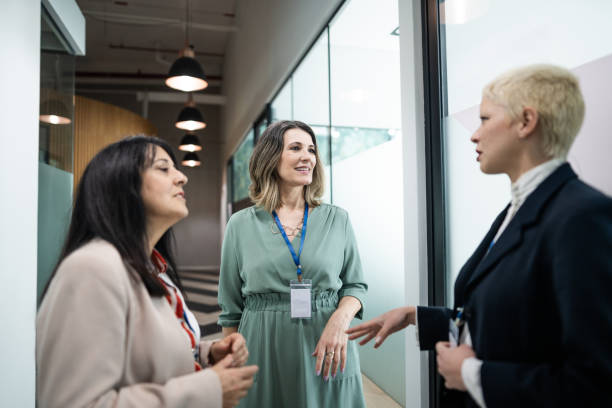 istock Coworkers talking at corridor during a business seminar 1621470958