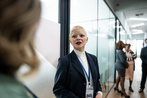 istock Coworkers talking at corridor during a business seminar 1621470973