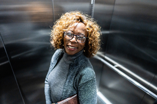 Portrait of a senior businesswoman inside of a elevator