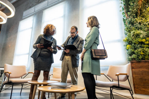istock Coworkers talking during a meeting at lobby office 1621477596