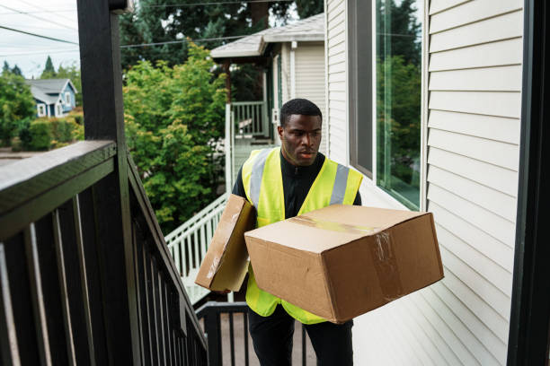 istock Delivery man walks up stairs, dropping off a package 1621478159