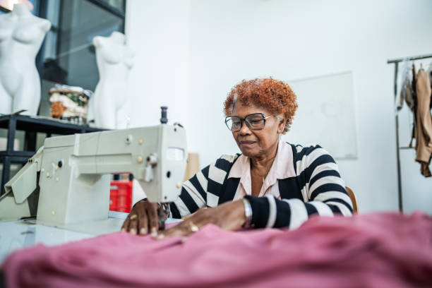 istock Senior woman using a sewing machine at atelier 1621495928