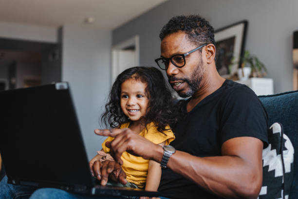 istock A father and daughter use video chat on a laptop computer 1621498030