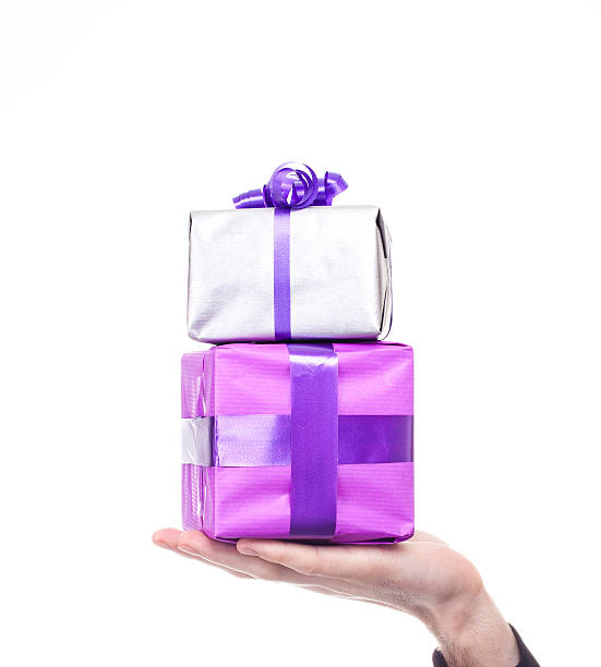 Man's hand holding gifts stock photo