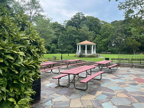 Piknik area with benches and tables, and a gazebo in the background