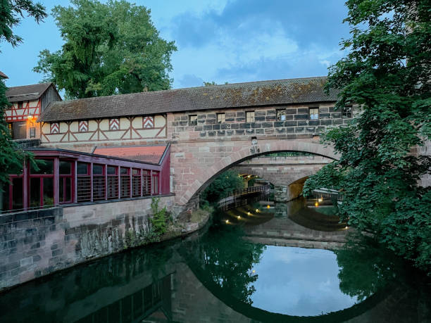 Nuremberg, Germany. Colourful and picturesque view of the half-timbered old houses and a bridge on the banks of the Pegnitz river.