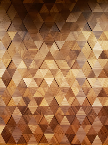 Decorative Background of a wooden wall made up of triangle pieces to form a pattern.