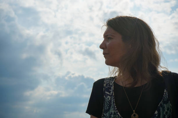 istock A woman looking away against sky 1621536630