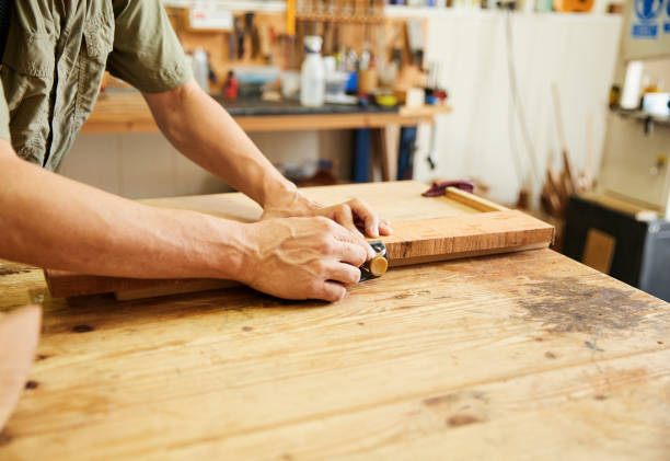 istock Luthier cutting wood to build a guitar 1621538319