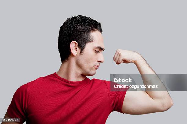 Młody Człowiek Napinać Mięśnie - zdjęcia stockowe i więcej obrazów Biceps - Biceps, Mężczyźni, Aktywny tryb życia