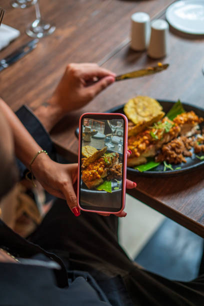 istock Couple is taking a photo of their dinner in a restaurant 1621547310