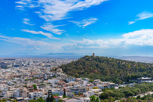 Panorama of Athens with Acropolis hill, Greece. Famous old Acropolis is top landmark of Athens. Skyline of Athens city, landscape with Greek ruins. Scenic panoramic view of remains of ancient Athens.